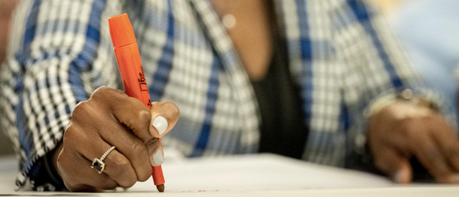 Person writing with marker