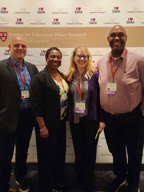 Attendees at convening in front of the SDP step-and-repeat